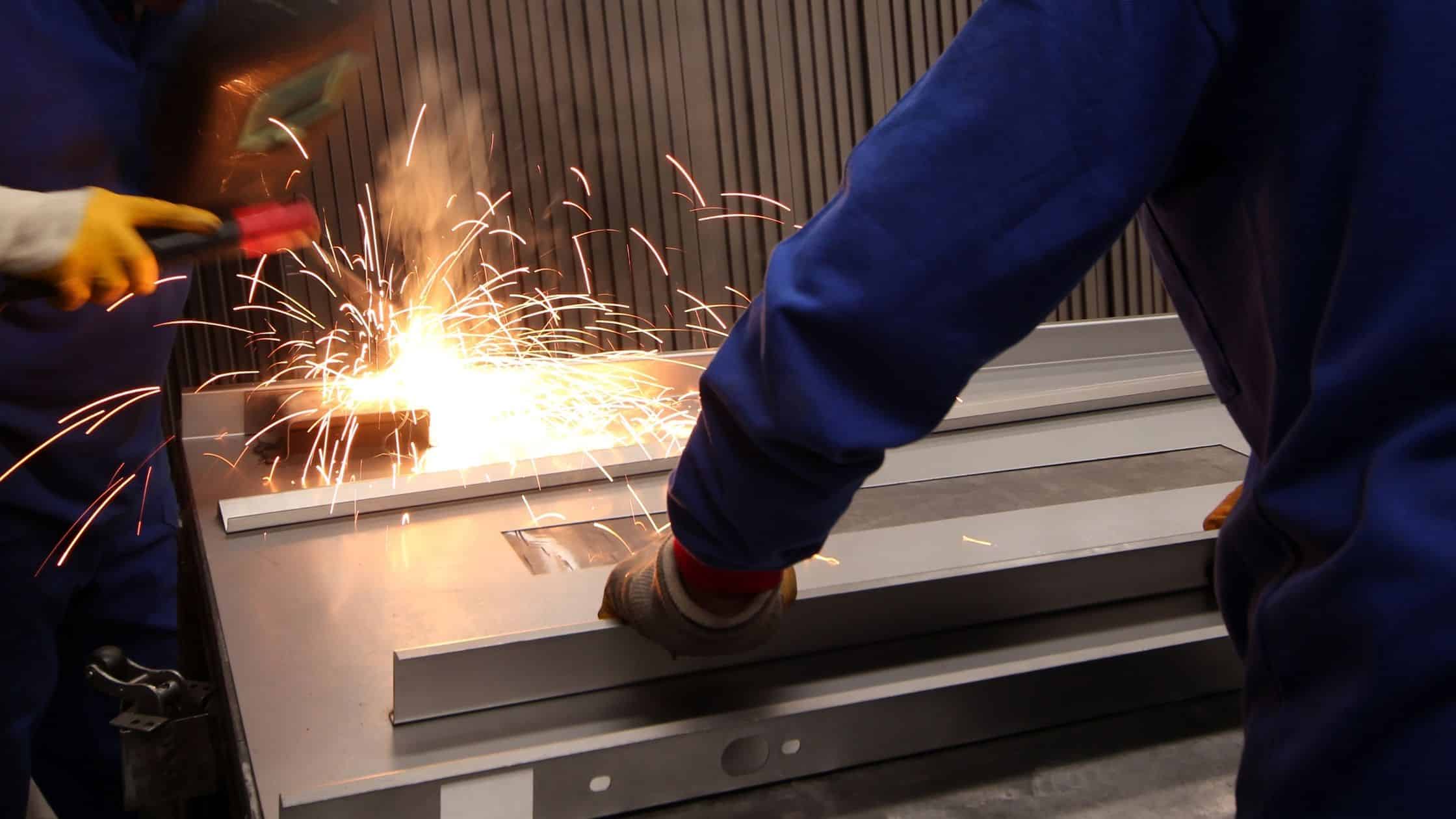 men working with metal sheets